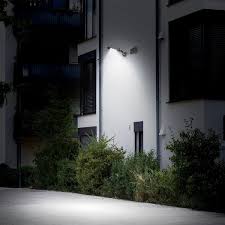 Solar wall-mount light on building exterior at night