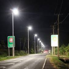 Solar LED street lights illuminating commercial road and parking at night